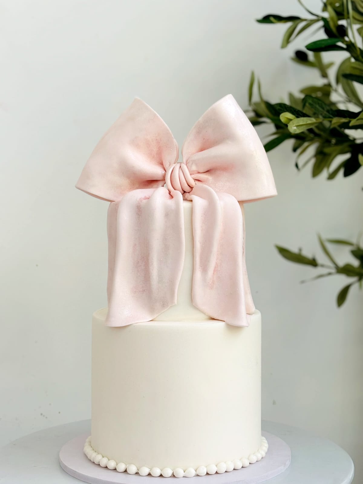 Maroon bow birthday cake with Hello 1 lettering