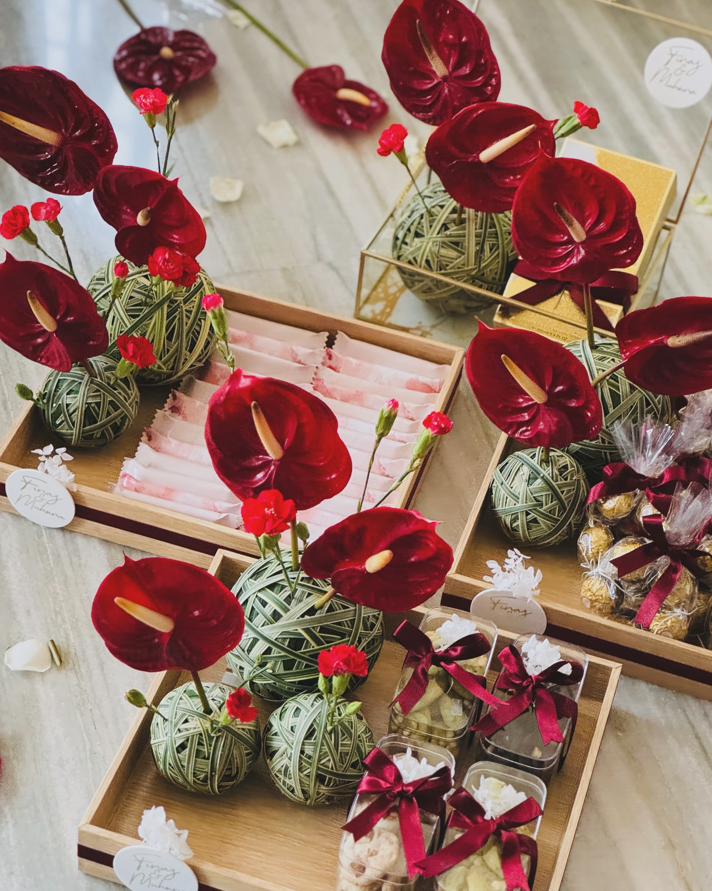 Floral hamper service with red flowers cookies chocolates and ribboned gift trays